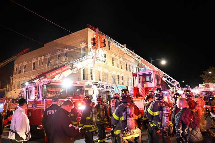 Over a hundred seventy five firefighters responded to a three alarm fire which heavily damaged a shoe store and apartments above, displacing 12 residents.
